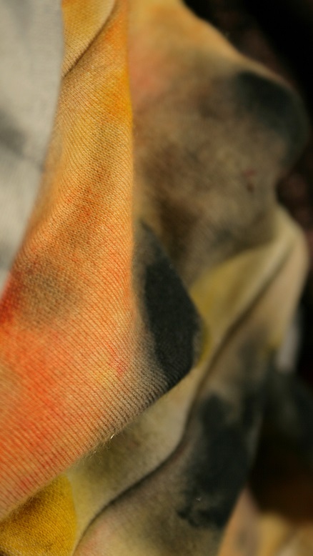 Abstract macro showing textured fabric with rough yellow and grey painting.